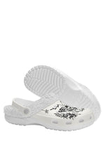 White sole view of death moth gothic slippers with black floral patterns