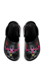 Top view of black clogs with neon pink and yellow moth print
