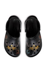 Black gothic slides with death moths, roses, and skulls, viewed from above