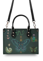 backside view of serpent and beetle-themed gothic handbag with black handles