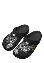 Angled view of death moth slippers with skull wings and floral prints