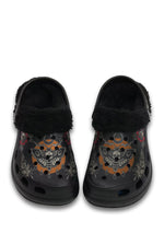 Front view of black fuzzy clogs with orange death moth and teardrop accents