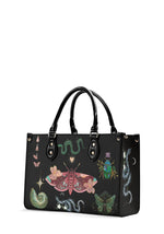 Mystic-themed black handbag with death moth and floral occult illustrations, side view
