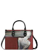 Red and black handbag featuring expressionist painting of a faceless humanoid