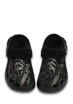 Top view of black fuzzy slippers with ghostface horror design