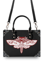 Overhead view of Cursed Moth Ritual Handbag with detachable strap attached
