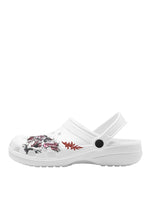 Side view of left white clog showing red flame and detailed pink-black moth tattoo design