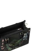 Top view of gothic handbag showing inner zip pocket and snake detail print near zipper