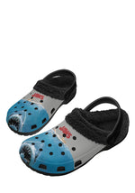 Angled side view of black JAWS slippers with ocean blue shark design