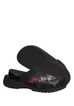 Sole view of black tattoo moth slipper showing textured outsole and side pattern