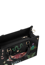Interior view of black moth handbag with structured handle and gold zipper
