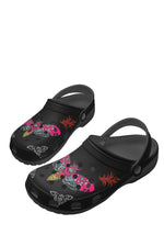 Angled rear view of black slippers with gothic tattoo moth pattern