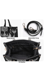 Close-up of gold-tone hardware and detachable strap on gothic handbag