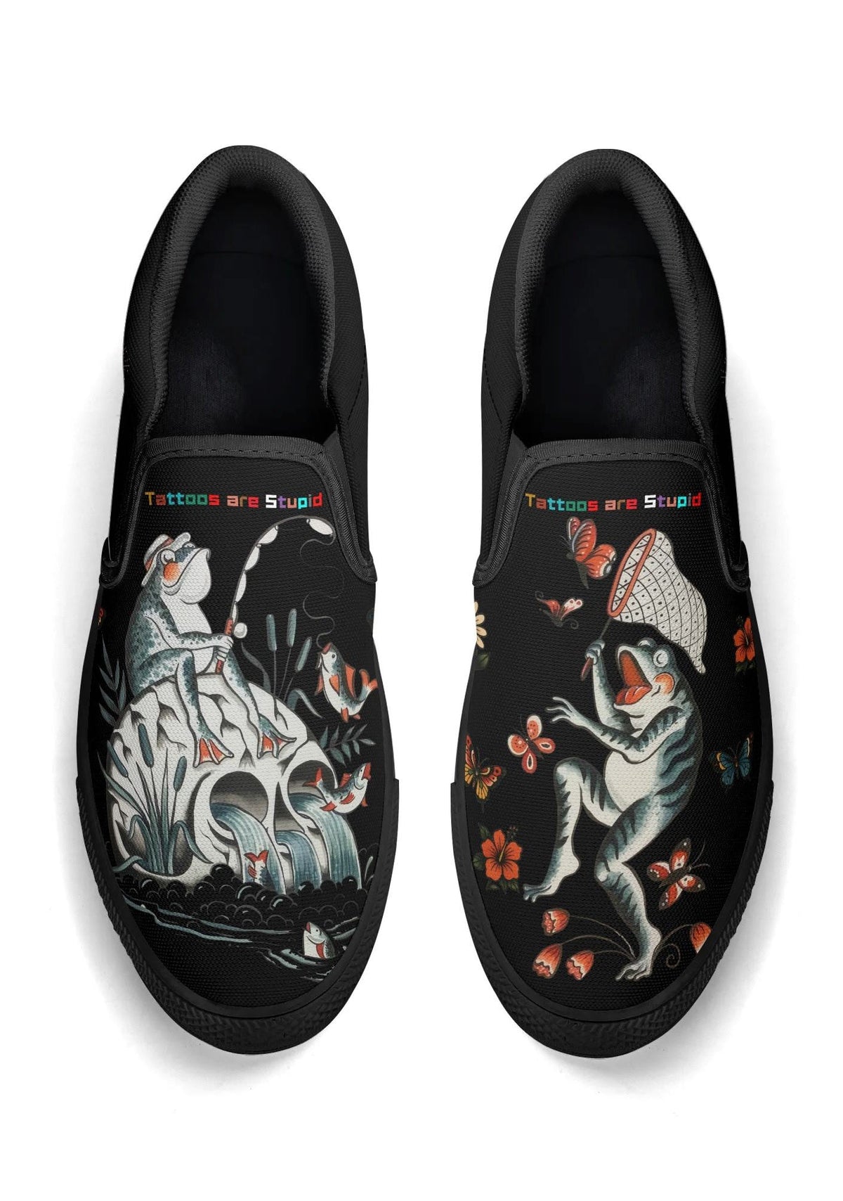 Top view of black slip-on shoes featuring frog fishing and dancing illustrations with "Tattoos are Stupid" text