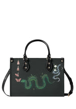 Front view of Serpent Bloom Ritual Handbag with glowing green snake and mystical floral print