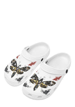 Angled front view of white Death Flame slippers featuring death moth and tribal flames