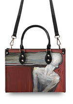 Back of structured handbag featuring anguished humanoid in abstract art