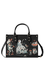 Black handbag with tattoo-style frogs fishing and mushroom pond scene