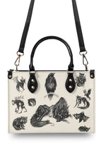 Back of the bag with horned beast and black handle detail