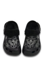 Front view of black fuzzy slippers with skull moth and chain design