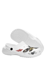 Bottom sole view of white slippers with tread pattern and gothic moth art