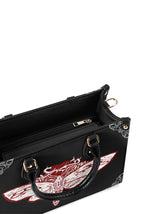 Inside view of the handbag showing zip pocket and spacious black interior