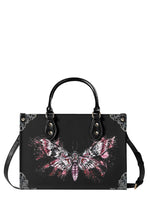 black gothic handbag with pink splatter-style death moth illustration and floral corner details