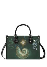 Gothic green handbag with spiral shell, cosmic star, and snake floral design on front