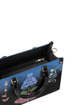 Interior view of handbag with black lining and inner zip compartment