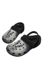 Angled view of surreal bunny print fuzzy slippers with dark fleece lining