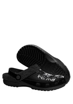 Underside and side view of black slippers with bold pinhead print
