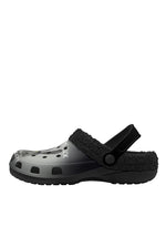 Side view of black fuzzy slippers with bold text and rabbit design