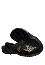 Bottom sole view of black fuzzy clog with tattoo-style moth illustration