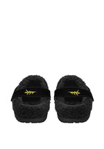 Back view of black fleece slippers with yellow tattoo flames