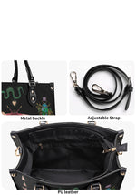Closeup of metal buckle, adjustable strap, and PU leather interior of gothic handbag